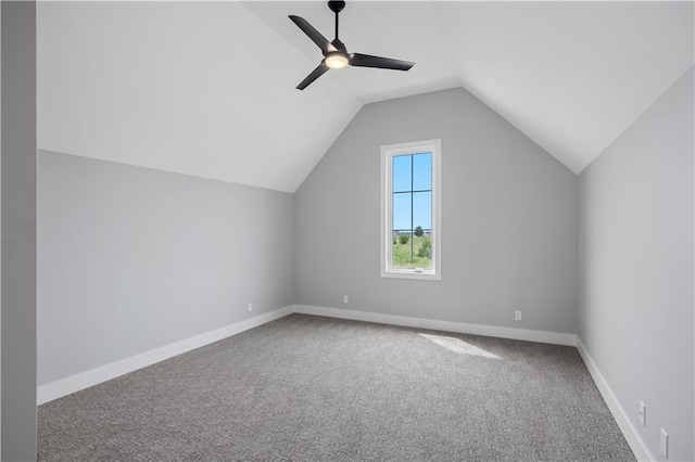 additional living space with carpet floors, vaulted ceiling, baseboards, and a ceiling fan