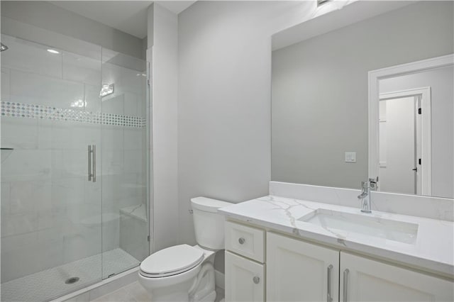 bathroom with a stall shower, tile patterned flooring, vanity, and toilet