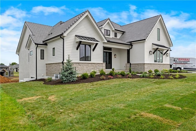 modern farmhouse style home featuring stone siding and a front lawn