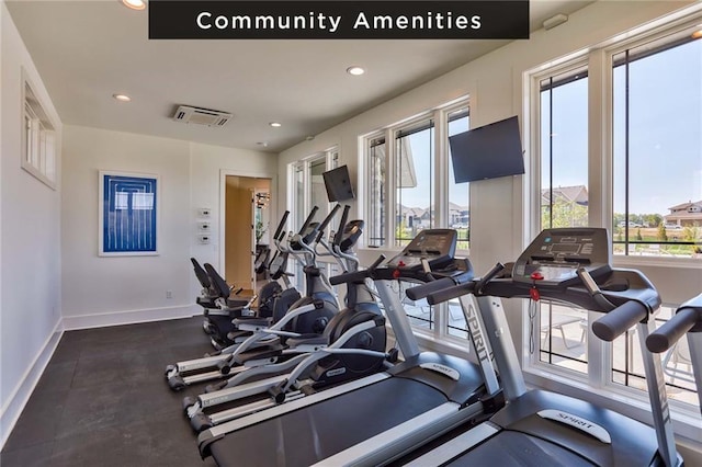 workout area featuring recessed lighting and baseboards