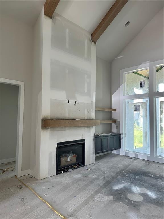 17321 Bluejacket St, Overland Park, KS 66221 - unfurnished living room featuring high vaulted ceiling, a glass covered fireplace, and beam ceiling