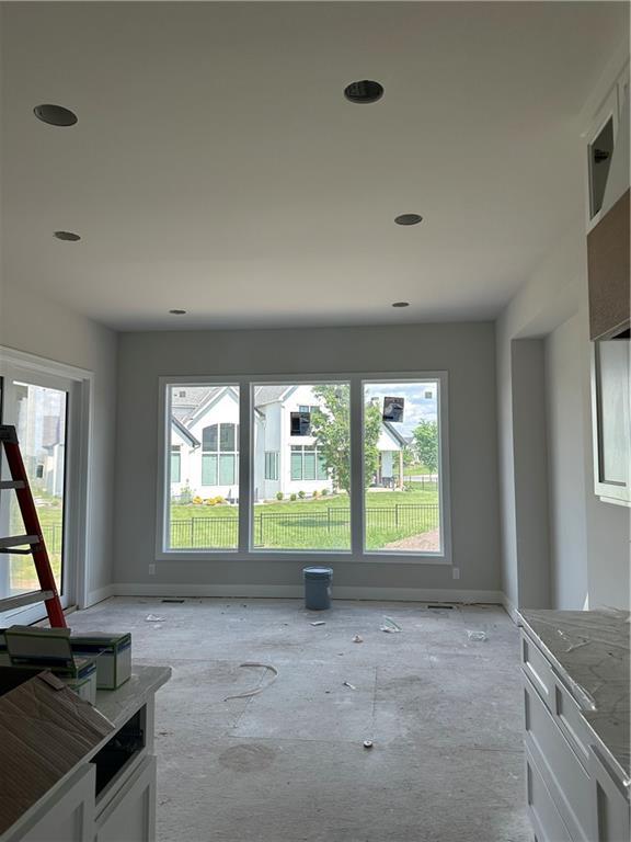 17321 Bluejacket St, Overland Park, KS 66221 - unfurnished living room with plenty of natural light, baseboards, and recessed lighting