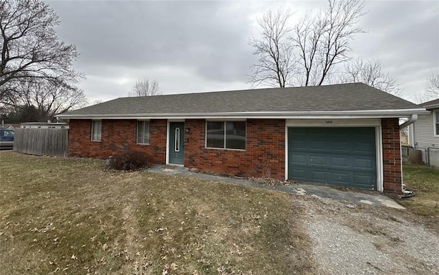 single story home with a shingled roof, brick siding, and fence