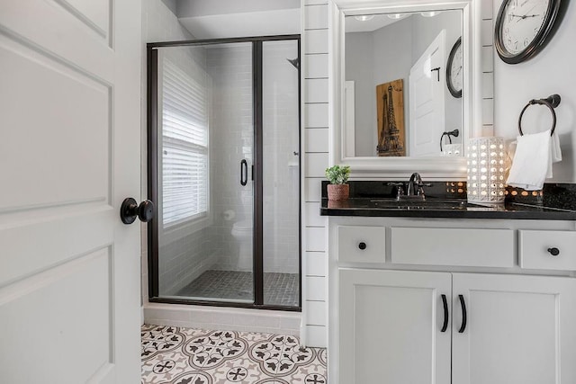 bathroom with tile patterned floors, vanity, and a shower stall