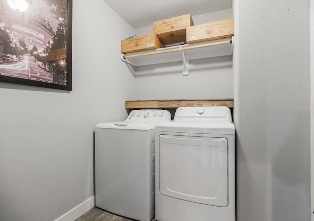 laundry area featuring baseboards, separate washer and dryer, and laundry area