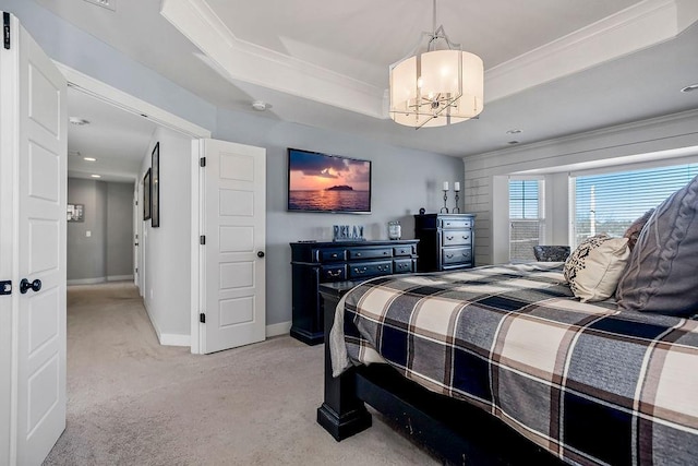 bedroom with a notable chandelier, ornamental molding, a tray ceiling, baseboards, and light colored carpet