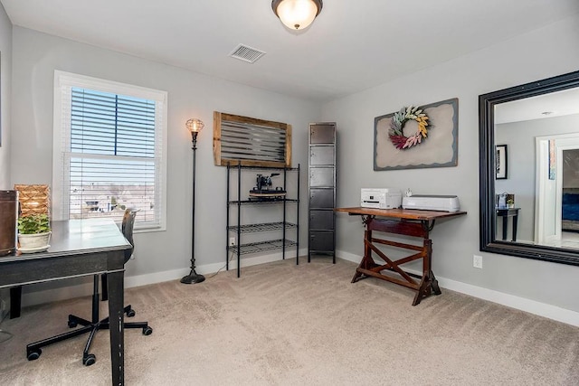 carpeted office with baseboards and visible vents