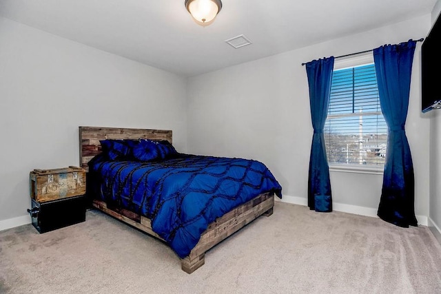 bedroom with visible vents, baseboards, and carpet