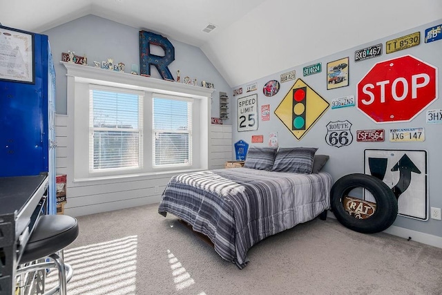 carpeted bedroom with lofted ceiling and visible vents