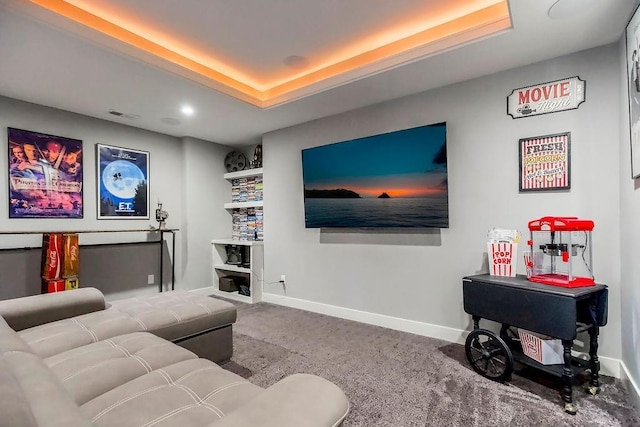 interior space with baseboards, carpet, and a raised ceiling