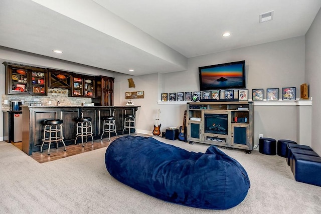 living room featuring visible vents, recessed lighting, a dry bar, and carpet floors