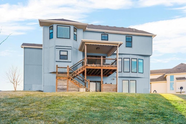 back of house featuring stairs, a deck, and a lawn