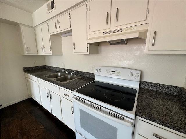 3112 Benton Blvd, Kansas City, MO 64128 - kitchen with white range with electric stovetop, dark countertops, dark wood-type flooring, under cabinet range hood, and a sink