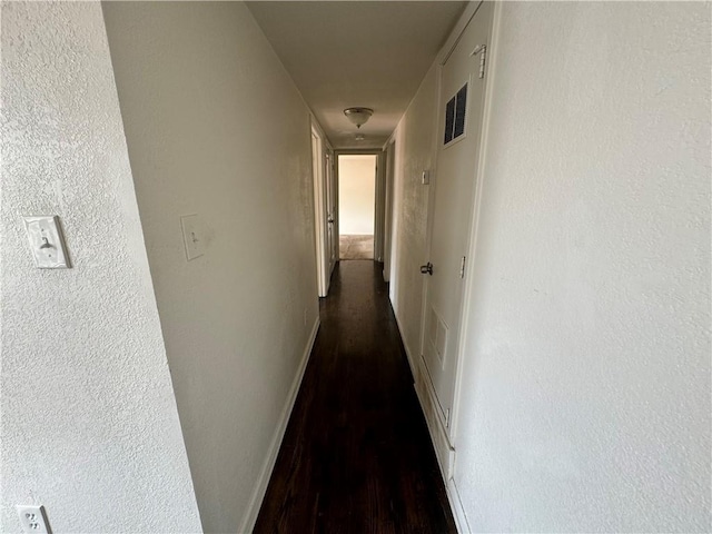 3112 Benton Blvd, Kansas City, MO 64128 - hall featuring visible vents, baseboards, and dark wood finished floors