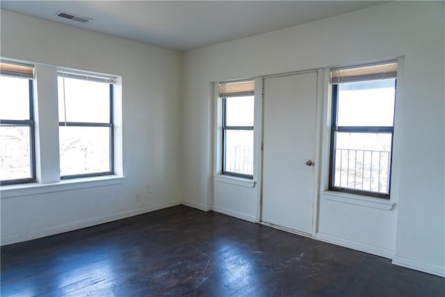 3112 Benton Blvd, Kansas City, MO 64128 - spare room with visible vents, plenty of natural light, baseboards, and wood finished floors