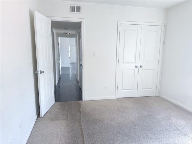 3112 Benton Blvd, Kansas City, MO 64128 - unfurnished bedroom featuring baseboards, a closet, visible vents, and carpet flooring