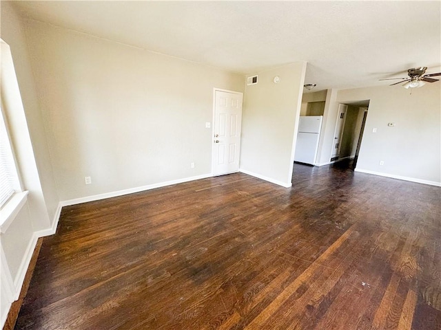 3112 Benton Blvd, Kansas City, MO 64128 - unfurnished room with visible vents, dark wood-style flooring, a ceiling fan, and baseboards