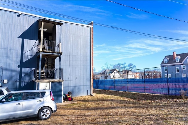 3112 Benton Blvd, Kansas City, MO 64128 - view of tennis court featuring stairs and fence