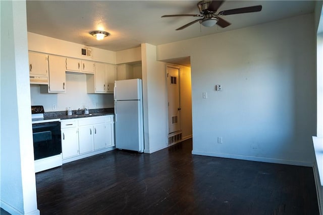 3112 Benton Blvd, Kansas City, MO 64128 - kitchen featuring visible vents, range with electric cooktop, dark wood finished floors, dark countertops, and freestanding refrigerator