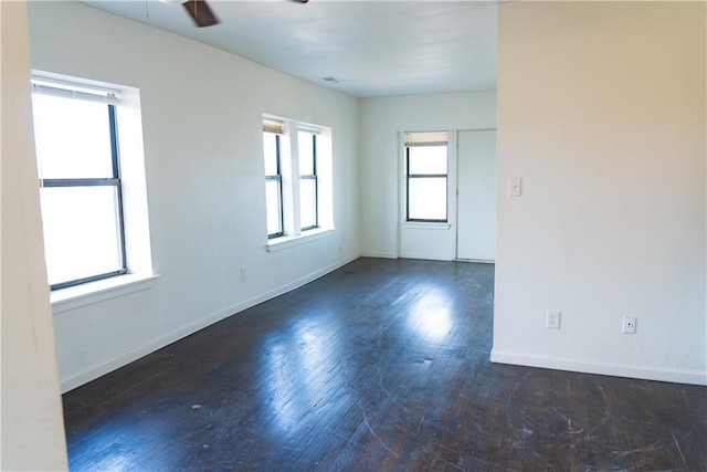 3112 Benton Blvd, Kansas City, MO 64128 - unfurnished room featuring a ceiling fan, visible vents, baseboards, and wood finished floors