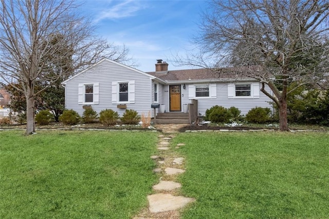 single story home featuring a chimney and a front lawn