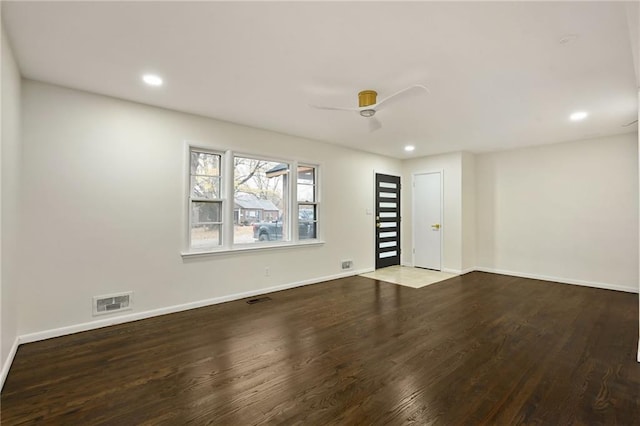 empty room with visible vents, baseboards, and wood finished floors