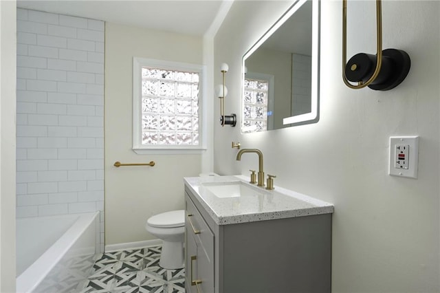 bathroom with vanity, toilet, and baseboards