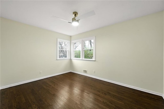 unfurnished room with dark wood-style floors, baseboards, and visible vents