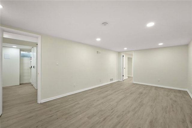 spare room with recessed lighting, visible vents, baseboards, and wood finished floors