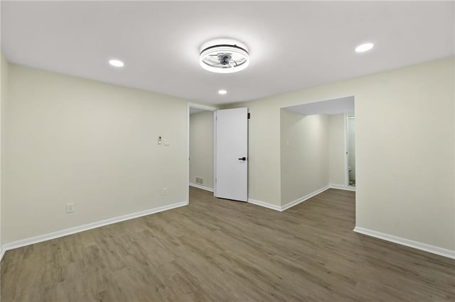 spare room featuring recessed lighting, visible vents, baseboards, and wood finished floors