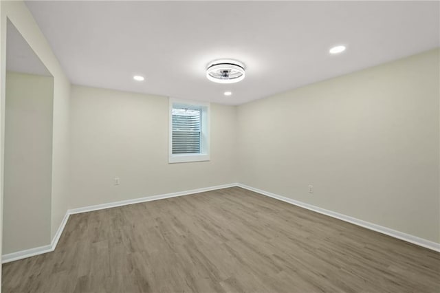 unfurnished room with recessed lighting, wood finished floors, and baseboards