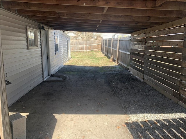 exterior space featuring fence and a carport