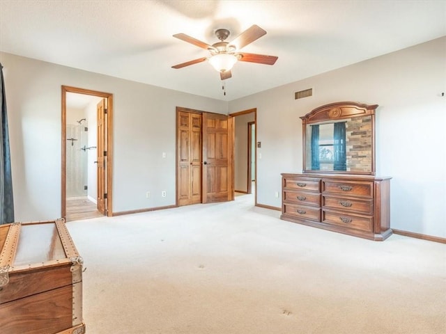 bedroom with visible vents, connected bathroom, carpet, and baseboards