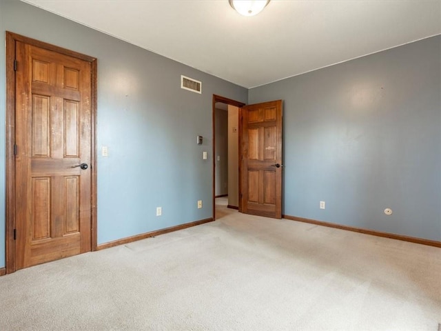 unfurnished bedroom featuring visible vents, baseboards, and carpet