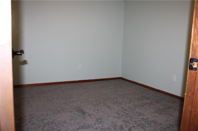 unfurnished room with baseboards and carpet floors