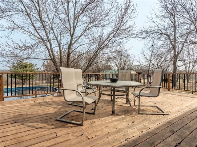 wooden deck featuring outdoor dining area