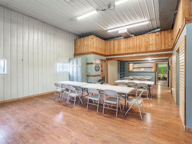 dining area featuring light wood-style floors and metal wall