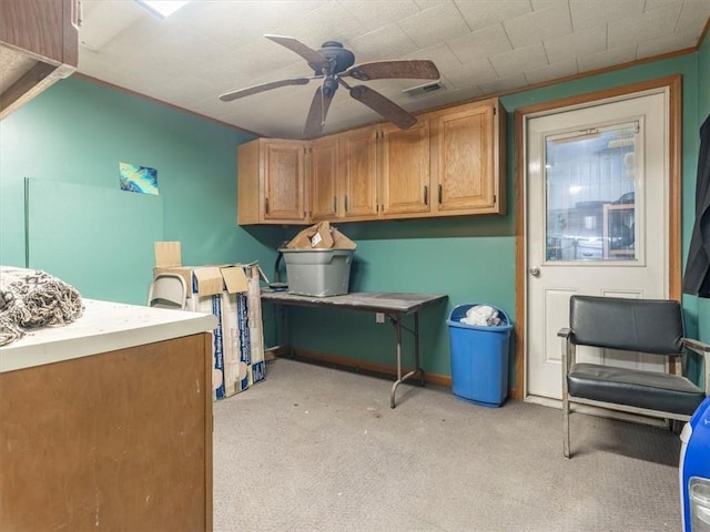 clothes washing area with ceiling fan, visible vents, and light carpet