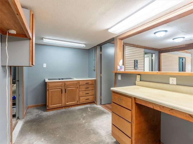 bathroom featuring unfinished concrete floors, baseboards, and a textured ceiling