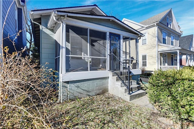 view of side of home featuring a sunroom