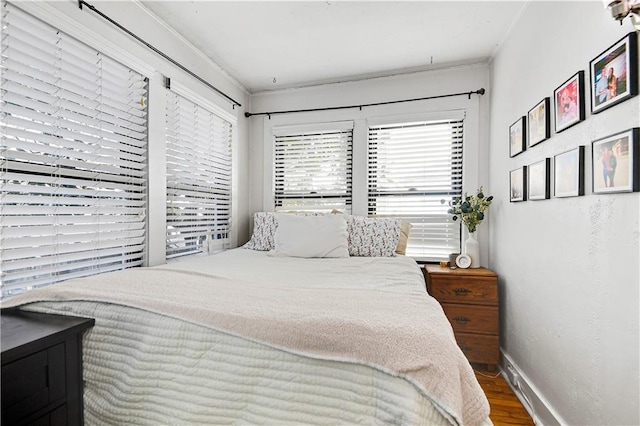 bedroom featuring wood finished floors and baseboards