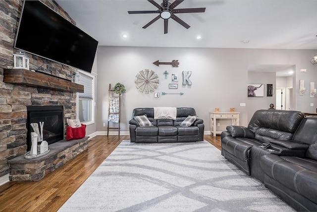 living room with recessed lighting, a fireplace, wood finished floors, and baseboards