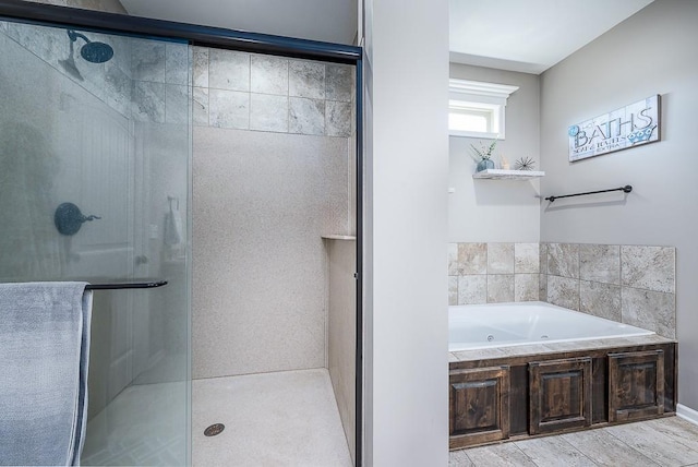 full bathroom featuring a whirlpool tub and a stall shower