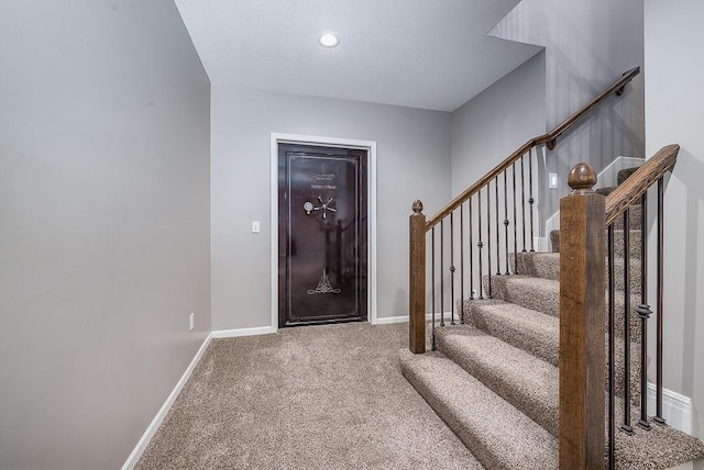 entrance foyer featuring stairs, carpet floors, and baseboards