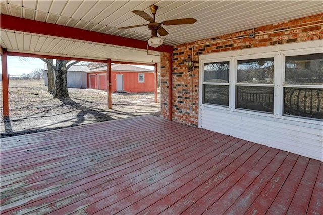 deck featuring an outdoor structure and ceiling fan