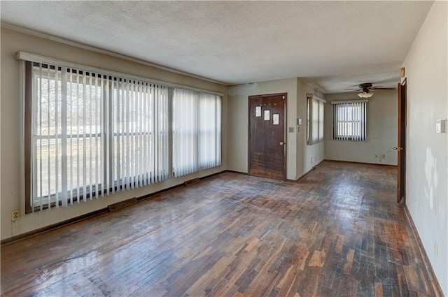 entrance foyer with baseboards, a textured ceiling, ceiling fan, and hardwood / wood-style floors