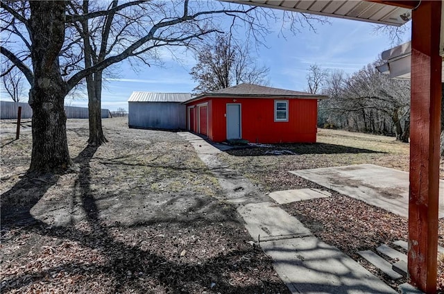 view of outdoor structure with an outbuilding and fence