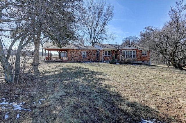 single story home with brick siding and a front yard