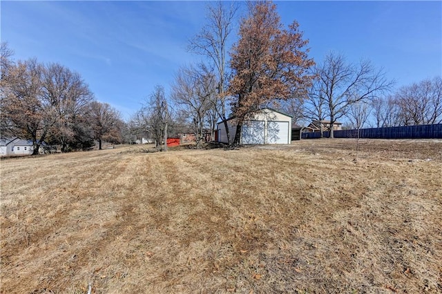 view of yard featuring a garage and an outdoor structure