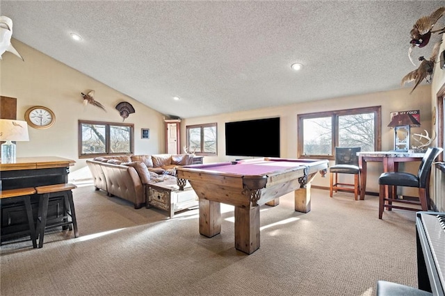 recreation room with lofted ceiling, plenty of natural light, and carpet flooring